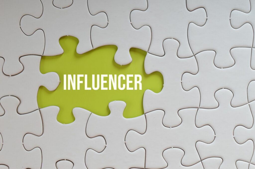 Green puzzle background written with text INFLUENCER.